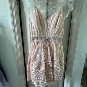Blush lace overlay mini dress with crystal and silk ribbon embellishment.